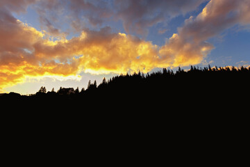 The black silhouette of the mountains, against the backdrop of a beautiful sunset in the mountains. place for text