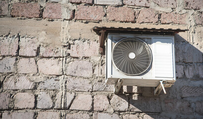 Air conditioner compressor on the wall.