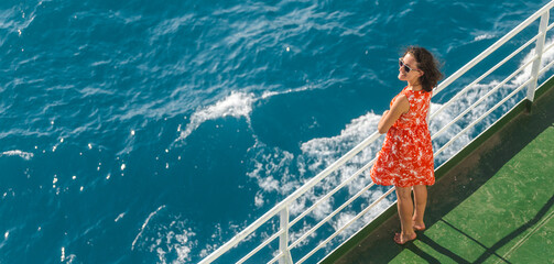 a woman is sailing on a cruise ship and looks at the water