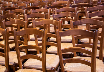 Fototapeta na wymiar Rows of wooden chairs in the church.