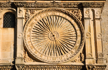 Ancient astronomical clock in Sun shape on the facade of famous Chartres cathedral, France.