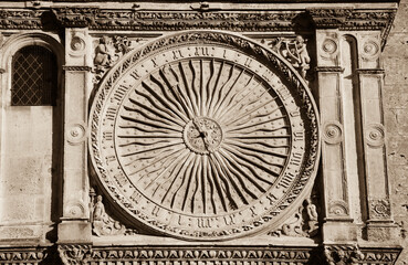 Ancient astronomical clock in Sun shape on the facade of famous Chartres cathedral, France. Sepia...