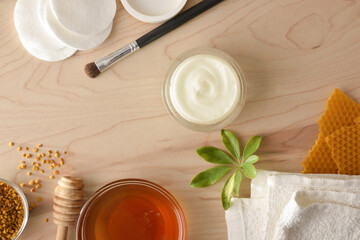 Cosmetics with honey extracts with tools on table top view
