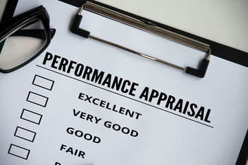 Top view of performance Appraisal checklist on clip board with glasses and white cover background. Performance review concept