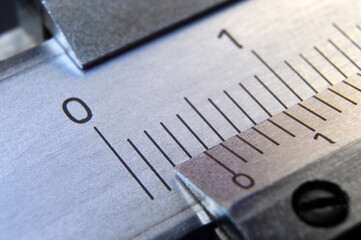 locksmith measuring tool lies on the background of metal rulers. close-up
