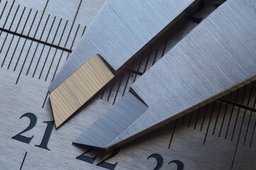 locksmith measuring tool lies on the background of metal rulers. close-up