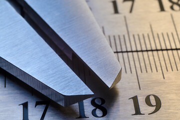 locksmith measuring tool lies on the background of metal rulers. close-up