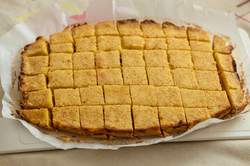Close-up of freshly baked diced orange cookies on the table. Food photo. Dessert.