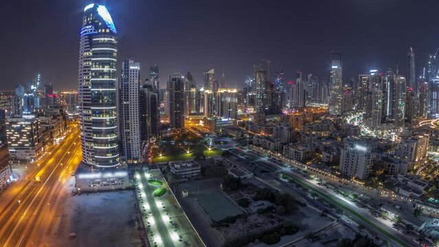 Dubai's business bay towers aerial all night timelapse. Rooftop view of some skyscrapers