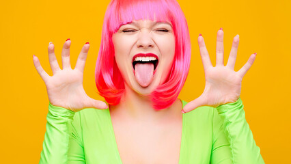 Beautiful female breasts in a green blouse on a yellow background and crossed arms