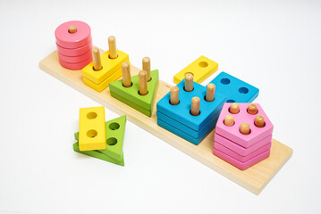 Obraz premium Wooden toy for baby, children isolated on white background. Shapes of different colors with holes.