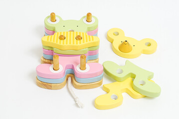 Wooden toy for baby, children isolated on white background. Different shapes of mouse with holes.