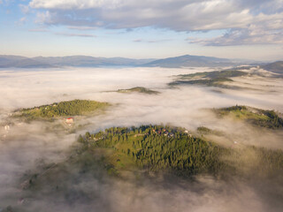 Green mountains of the Ukrainian Carpathians in the morning fog. Aerial drone view.