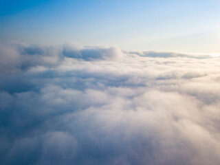 Fototapeta na wymiar High flight above the clouds. Aerial drone view.
