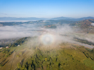 Morning mist in Ukrainian Carpathian mountains. Aerial drone view.