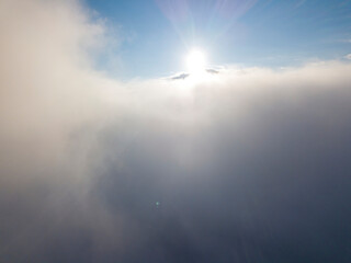 Naklejka na ściany i meble High flight above the clouds. Aerial drone view.