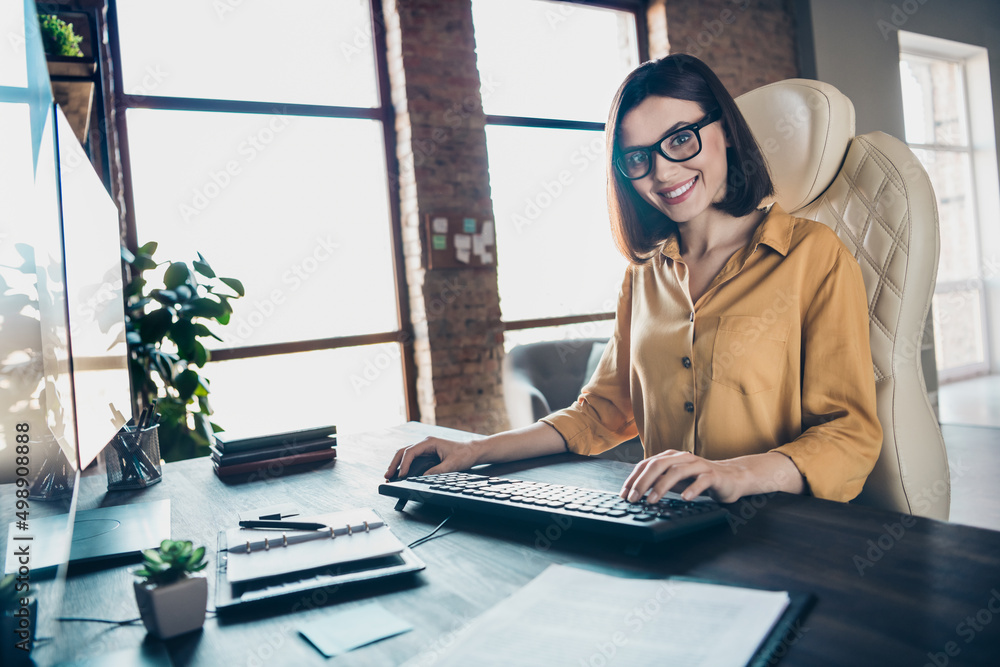 Sticker Portrait of cheerful pretty lady sitting chair create database look camera toothy smile workplace indoors