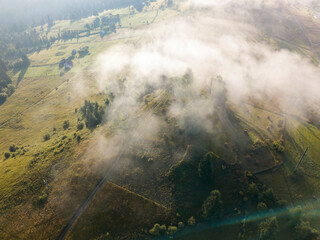 Green mountains of the Ukrainian Carpathians in the morning mist. Aerial drone view.