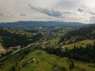 Settlement in the mountains of the Ukrainian Carpathians. Aerial drone view.