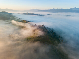 Obraz premium Morning mist in Ukrainian Carpathian mountains. Aerial drone view.
