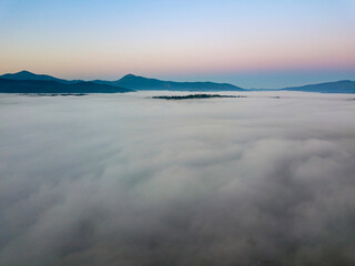 Naklejka na ściany i meble Morning fog in the Ukrainian Carpathians. Aerial drone view.