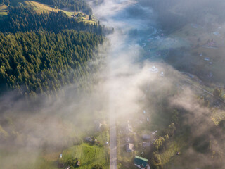 Obraz premium Morning fog in the Ukrainian Carpathians. Aerial drone view.