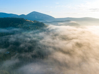 Sunrise over the fog in the Ukrainian Carpathians. Aerial drone view.
