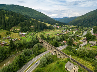 Old railway bridge in the mountains. Ukrainian Carpathians. Aerial drone view.