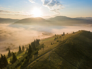 Sunrise over the fog in the Ukrainian Carpathians. Aerial drone view.