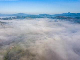 Morning mist in Ukrainian Carpathian mountains. Aerial drone view.