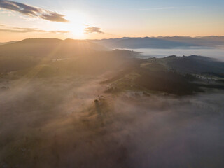 Sunrise over the fog in the Ukrainian Carpathians. Aerial drone view.