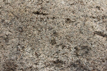 Rough gray stone or texture of mountains, background and space for copying text on the topic of geology and mountaineering.