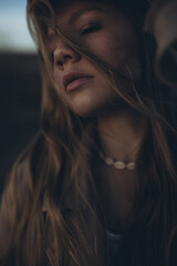 Beautiful young girl at sunset by the sea. High quality photo