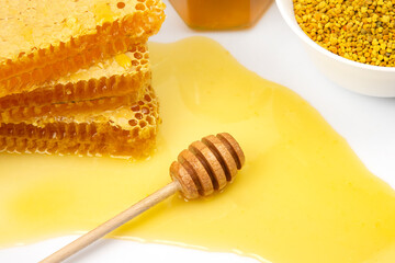 Fresh flower honey in combs and a wooden spoon. vitamin food for health and life