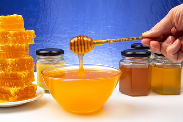 fresh floral honey dripping from a spoon into a plate. organic vitamin health food
