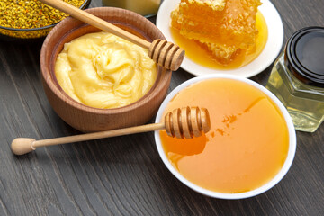 Fresh flower honey of different varieties, pollen and honeycomb with spoons on a wooden background. Organic Vitamin Health Food