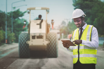 African civil engineering working with use tablet for control the road rebuilding and inspect the...