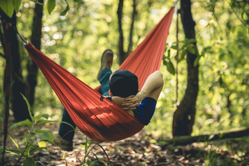 Relaxing in hammock in tropical forest