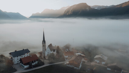 swiss alpine village fog morning