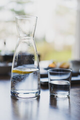glass of water and a decanter on the table in the cafe