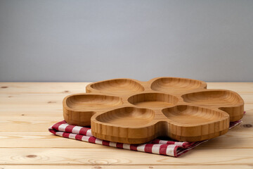 Cutting board with cotton napkin on wooden table