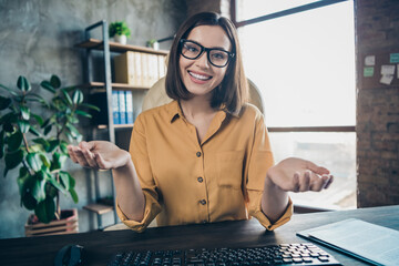 Portrait of attractive positive person sit chair speak communicate video call office indoors