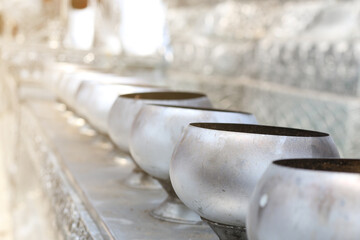 The row of metal monk's alms bowls in a temple.