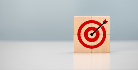 Initiation for planning to reach target. Darts target aim icon on wooden cubes with grey...