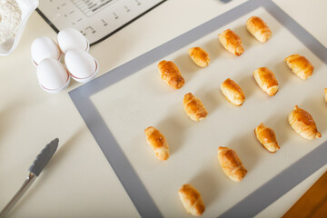 Freshly baked sweet dessert homemade pastries - bagels on a baking mat