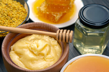 Fresh flower honey of different varieties, pollen and honeycomb with spoons on a wooden background. Organic Vitamin Health Food