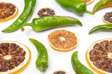 hot green peppers and dried citrus fruit on a white background. grocery organic flatley