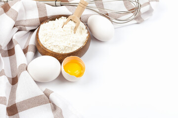 Baking ingredients chicken eggs and flour on white background