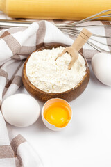 Baking ingredients chicken eggs and flour on white background