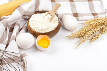 Baking ingredients chicken eggs and flour on white background